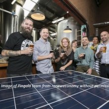 people in front of a solar panel holding beer